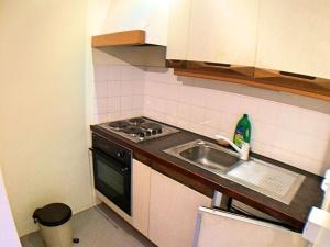 a small kitchen with a sink and a stove at Appartement Vars, 2 pièces, 4 personnes - FR-1-330B-63 in Vars