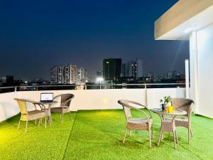 a patio with a table and chairs on a roof at Olive Service Apartments - City Centre Noida in Noida