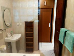 a bathroom with a sink and a shower with a mirror at Lafayette House Canggu Bali in Canggu