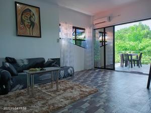 a living room with a couch and a table at CHIEF'S VILLA Rentals Malapascua Island in Malapascua Island