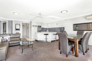 a living room with a couch and a table at Burleigh Surf - Hosted by Burleigh Letting in Gold Coast