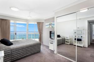 a bedroom with a bed and a view of the ocean at Burleigh Surf - Hosted by Burleigh Letting in Gold Coast +7 photos