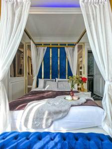 a bedroom with a large white bed with at Exquisite Pool Villa J - Pattaya Pool Villa in Pattaya South