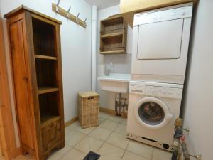 a laundry room with a washing machine and a sink at Chalet Le Grand-Bornand, 8 pièces, 11 personnes - FR-1-391-22 in Le Grand-Bornand