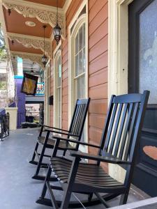 three black chairs sitting on the side of a building at Beautifully updated New Orleans home in New Orleans