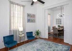 a living room with blue chairs and a table at Beautifully updated New Orleans home in New Orleans