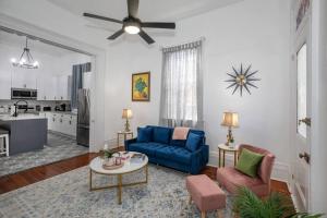 a living room with a blue couch and a table at Beautifully updated New Orleans home in New Orleans +30 photos