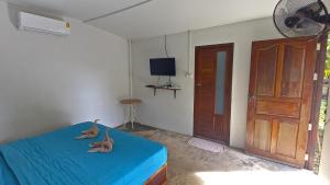 Un dormitorio con una cama azul con dos ratones. en Sea Culture, en Ko Lanta