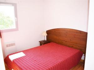 a red bed in a white room with a window at Maison Duplex 6 Pers. avec Terrasse, Piscine Chauffée, Parking Gratuit - Vallon-Pont-d'Arc - FR-1-382-55 in Vallon-Pont-dʼArc +5 photos