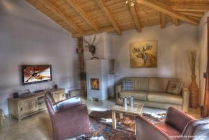 a living room with a couch and a fireplace at Residenz an der Burg by Kaprun Rentals in Kaprun