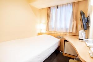 Una cama o camas en una habitación de le Lac Hotel Yokkaichi
