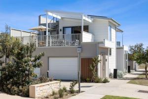 a large white house with a garage at Park View Townhouse With Rooftop Terrace in Torquay