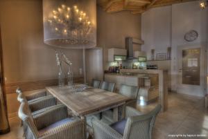 a dining room with a wooden table and chairs at Residenz an der Burg by Kaprun Rentals in Kaprun