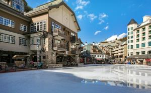 a large pool in the middle of a city with buildings at Beaver Creek Pines 3 Bedroom Ski In, Ski Out Vacation Rental With Restaurant, Outdoor Pool, Jacuzzi And Fitness Center in Beaver Creek