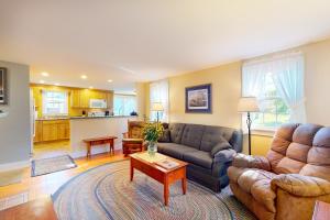 a living room with a couch and a table at Montgomery Cottage in Rockland