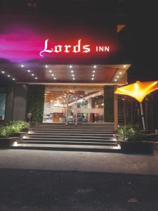 a restaurant with a lit up sign in front of it at Lords Inn Rajkot in Rajkot