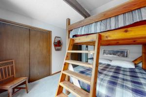 a bedroom with two bunk beds and a ladder at Mountain Living in Avon