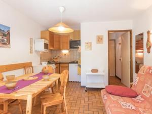 勒莫內蒂耶萊班的住宿－Appartement Le Monêtier-les-Bains, 2 pièces, 5 personnes - FR-1-330F-75，厨房以及带木桌和椅子的用餐室。