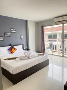 a bedroom with a large bed with a bow on it at Holiday Home Patong in Patong Beach