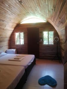 a bedroom with a bed in a wooden room at tayrona breeze in Santa Marta