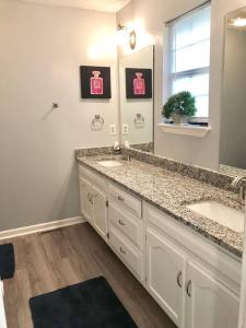 a bathroom with two sinks and a large mirror at Entire House Chattanoogas Best in Chattanooga