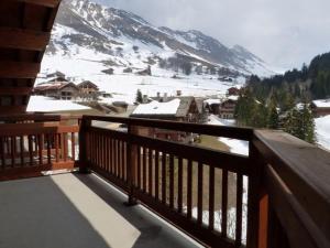 a balcony with a view of a snow covered mountain at Appartement Le Grand-Bornand, 4 pièces, 8 personnes - FR-1-458-147 in Le Grand-Bornand