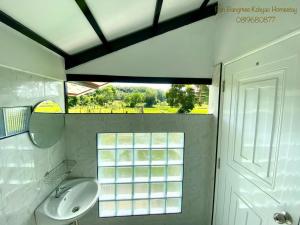 a bathroom with a sink and a window at Bang Mee Homestay Koh Yao Noi in Ko Yao Noi