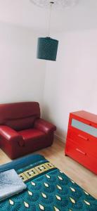 - un salon avec un canapé rouge et une commode rouge dans l'établissement Chez Erwan & Elizabeth, à Rennes