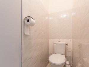 a bathroom with a toilet and a roll of toilet paper at Appartement Saint-Chaffrey , 1 pièce, 4 personnes - FR-1-330E-95 in Saint-Chaffrey