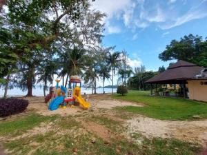 a playground with a slide on the beach at Supalai Scenic Bay Resort And Spa, SHA Extra Plus in Por Bay
