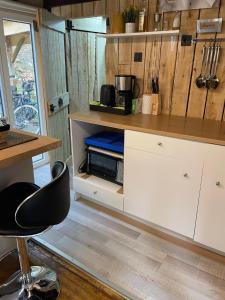 a kitchen with a counter and a chair in a room at Lalas'house in Philippeville