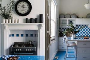 a kitchen with blue and white tiles and a clock on the wall at Carrington House Daylesford in Daylesford