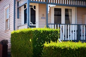 a house with a front porch and a fence at Charlies Daylesford in Daylesford