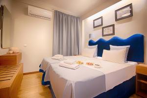 Postel nebo postele na pokoji v ubytování FALIREON HOTEL