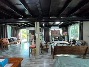 a living room with a couch and a table at BanLomLak in Sukhothai