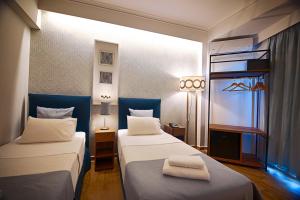Postel nebo postele na pokoji v ubytování FALIREON HOTEL