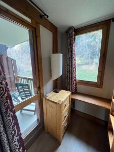 a room with a window and a table with a lamp at Superbe Appartement à Montchavin in Montchavin
