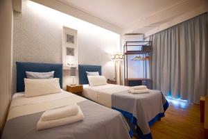 Postel nebo postele na pokoji v ubytování FALIREON HOTEL