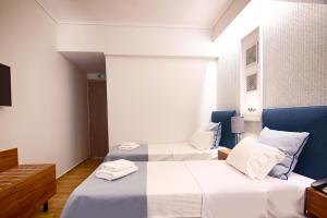Postel nebo postele na pokoji v ubytování FALIREON HOTEL