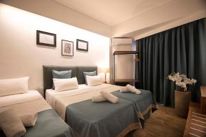 Postel nebo postele na pokoji v ubytování FALIREON HOTEL