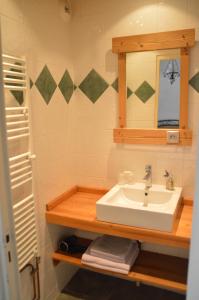 a bathroom with a sink and a mirror at Hotel Le Genepy in Tignes