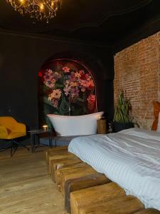 a bedroom with a bath tub and a bed at World Studio Sibiu in Sibiu