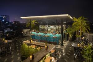 a bar on the roof of a building at night at Meritel Hanoi in Hanoi