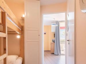 a bedroom with a bunk bed and a door to a bathroom at Appartement Briançon, 1 pièce, 4 personnes - FR-1-330C-18 in Briançon