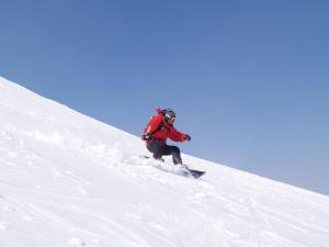 a person is skiing down a snow covered slope at Hotel Sunplaza Tsugaike in Otari +66 photos