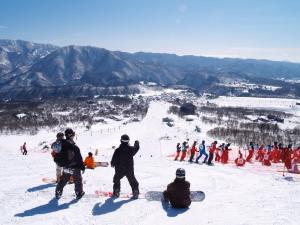 a group of people on a snow covered mountain at Hotel Sunplaza Tsugaike in Otari