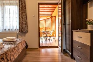 a bedroom with a bed and a table on a patio at Casa Tofi Vendégház in Praid