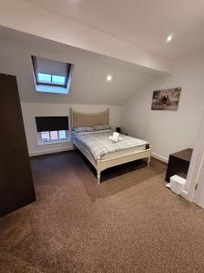 a bedroom with a bed and a skylight at 3 Laurel Court in Ulverston