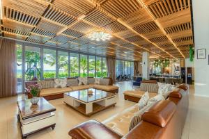 a large living room with couches and tables at The Ocean Villa Resort Beachfront By Abogo in Da Nang