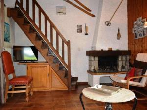 a living room with a staircase and a fireplace at Appartement Le Grand-Bornand, 2 pièces, 5 personnes - FR-1-241-167 in Le Grand-Bornand